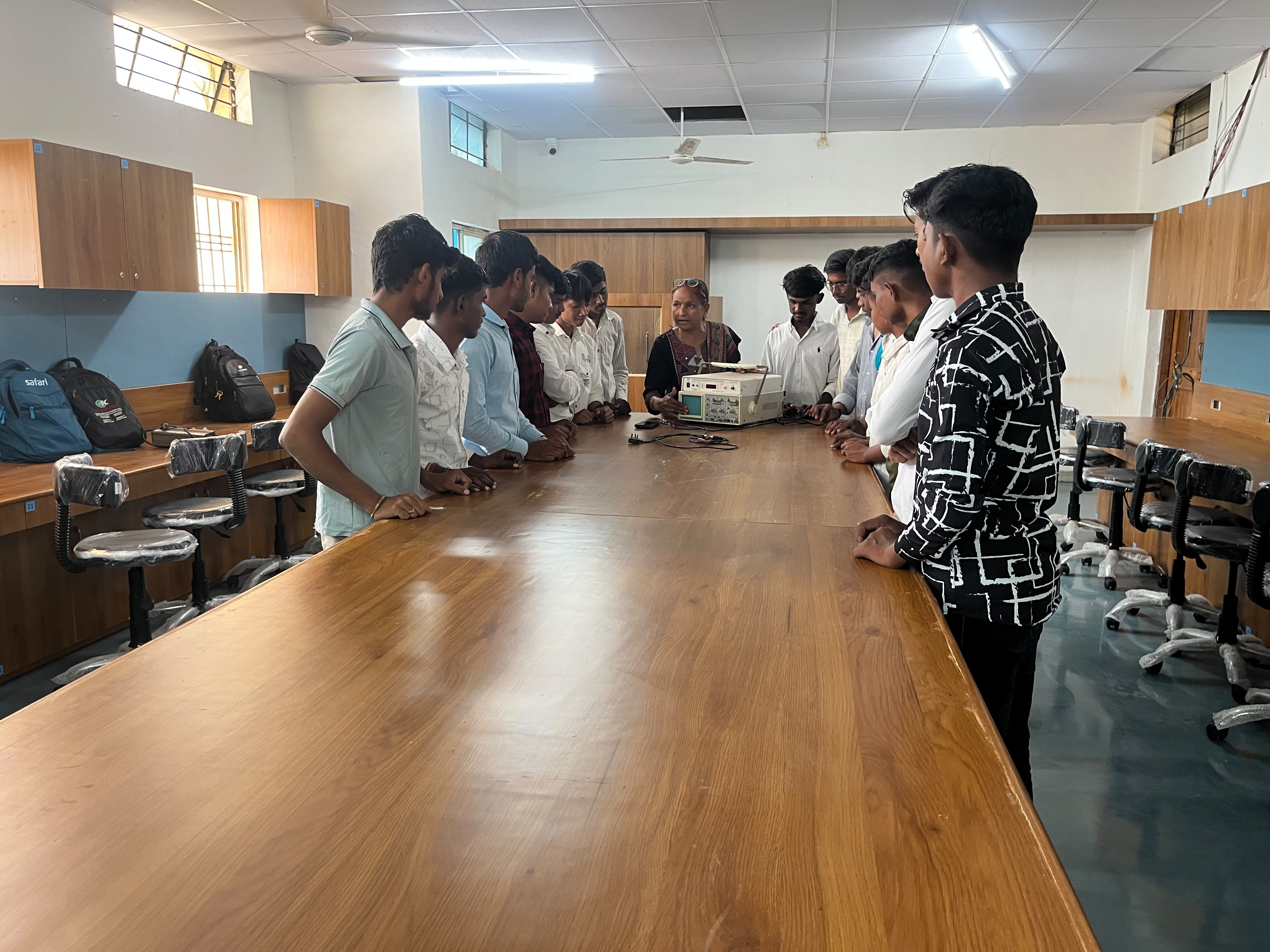 Electronics mechanic trainees gathered for a lab demonstration